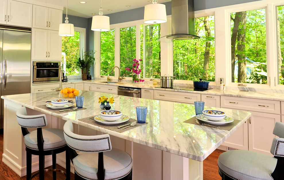 Inspiration for a large transitional u-shaped medium tone wood floor kitchen remodel in DC Metro with an undermount sink, shaker cabinets, white cabinets, granite countertops, stainless steel appliances and an island