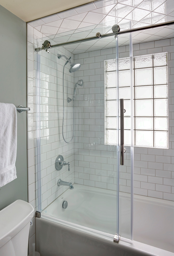 Example of a mid-sized transitional white tile and subway tile mosaic tile floor bathroom design in Chicago with shaker cabinets, white cabinets, a two-piece toilet, blue walls, an undermount sink and solid surface countertops