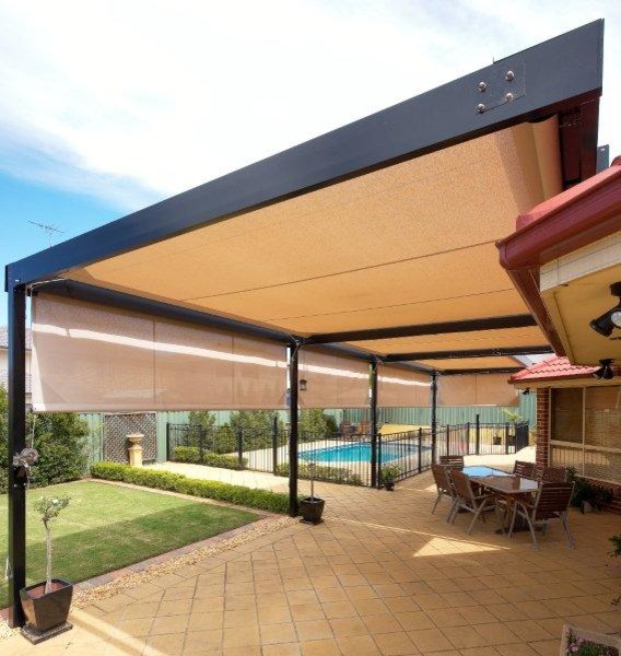 This is an example of a contemporary backyard screened-in verandah in Sydney with concrete pavers and an awning.