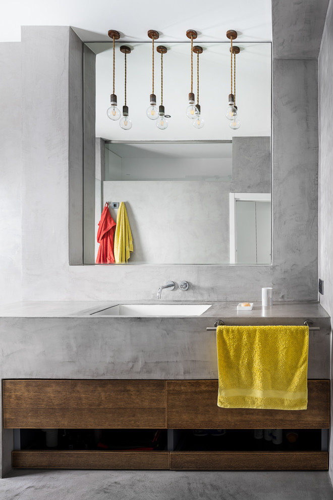 Design ideas for a contemporary bathroom in Seville with flat-panel cabinets, dark wood cabinets, grey walls, an undermount sink, grey floor and grey benchtops.