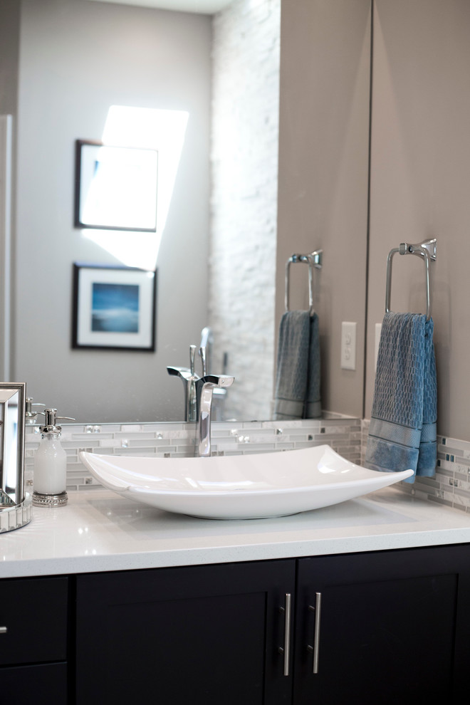 Inspiration for a large transitional master white tile and porcelain tile porcelain tile freestanding bathtub remodel in Wichita with shaker cabinets, black cabinets, gray walls, a vessel sink and quartz countertops