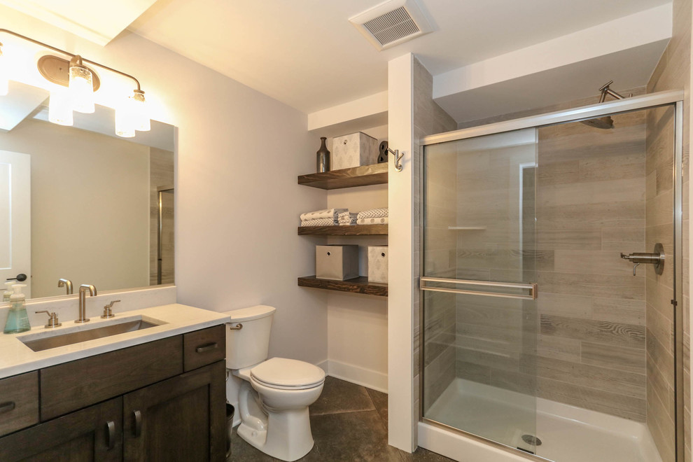This is an example of a mid-sized country kids bathroom in Chicago with flat-panel cabinets, white cabinets, an alcove tub, a corner shower, white tile, ceramic tile, white walls, ceramic floors, an undermount sink, engineered quartz benchtops, grey floor, a shower curtain and white benchtops.