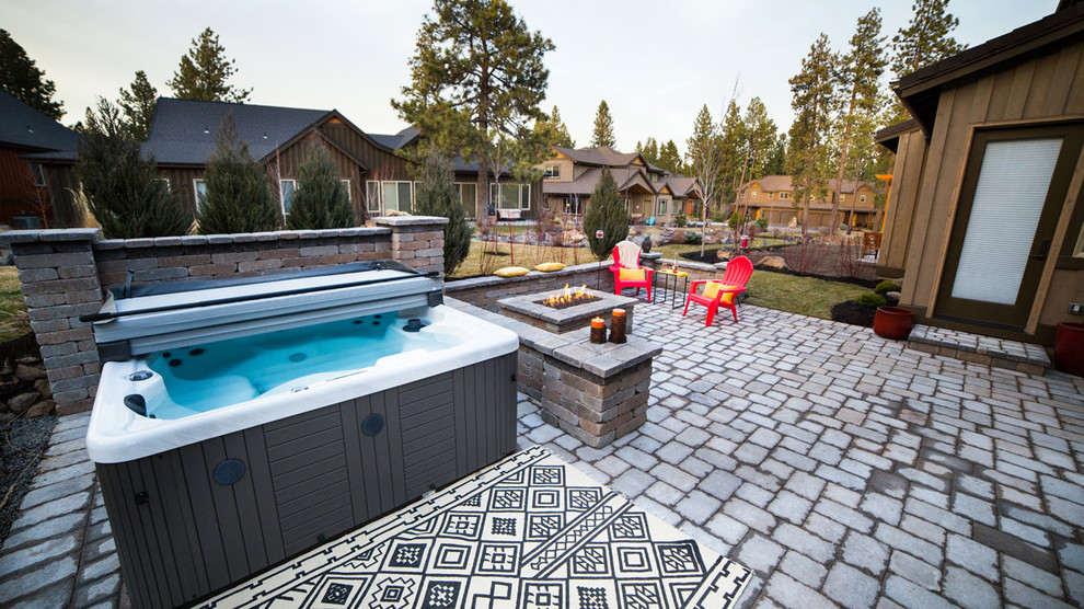 Patio - large contemporary backyard concrete paver patio idea with a fire pit and no cover