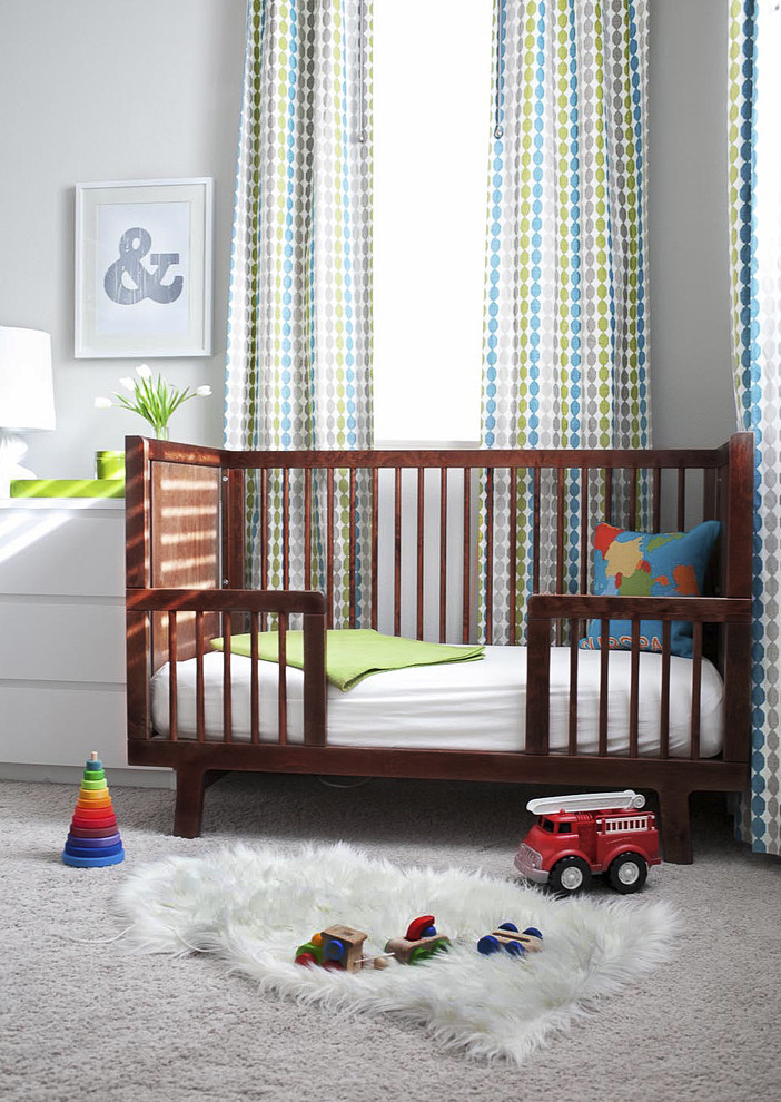 This is an example of a traditional gender-neutral nursery in San Francisco with grey walls and carpet.