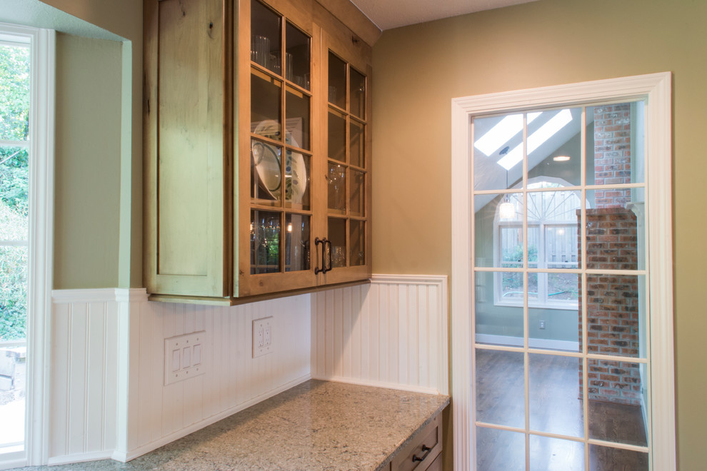 Enclosed kitchen - mid-sized rustic u-shaped medium tone wood floor enclosed kitchen idea with a farmhouse sink, shaker cabinets, medium tone wood cabinets, granite countertops, beige backsplash, ceramic backsplash, stainless steel appliances and an island