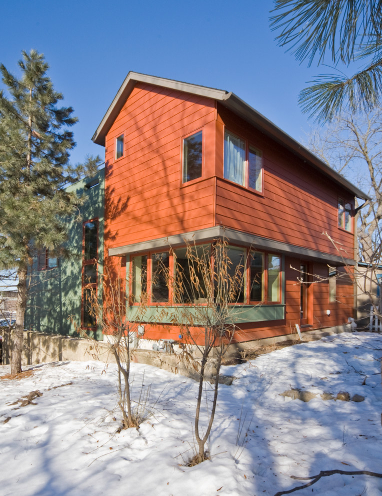Inspiration for a large modern three-storey orange exterior in Other with mixed siding and a gable roof.