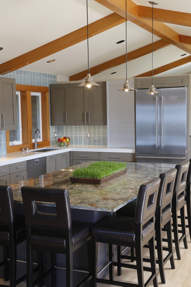 Inspiration for a mid-sized transitional l-shaped light wood floor open concept kitchen remodel in Seattle with an undermount sink, recessed-panel cabinets, gray cabinets, quartz countertops, blue backsplash, ceramic backsplash, stainless steel appliances and an island