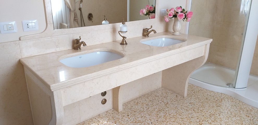 Large traditional bathroom in Milan with a corner tub, an alcove shower, a wall-mount toilet, yellow tile, marble, yellow walls, an undermount sink, marble benchtops, yellow floor, a hinged shower door and yellow benchtops.