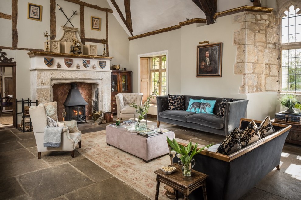 Design ideas for a large traditional formal open plan living room in Wiltshire with white walls, limestone flooring, a standard fireplace, a stone fireplace surround and beige floors.