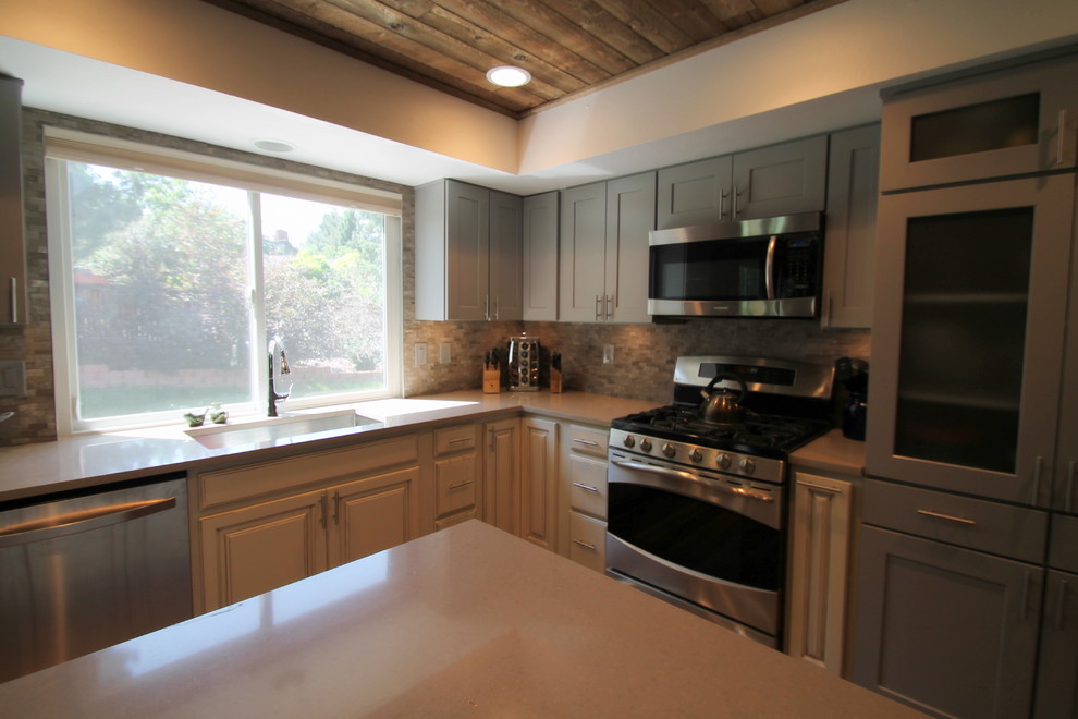 Large transitional l-shaped medium tone wood floor eat-in kitchen photo in Denver with an undermount sink, shaker cabinets, gray cabinets, quartz countertops, gray backsplash, stone tile backsplash, stainless steel appliances and an island