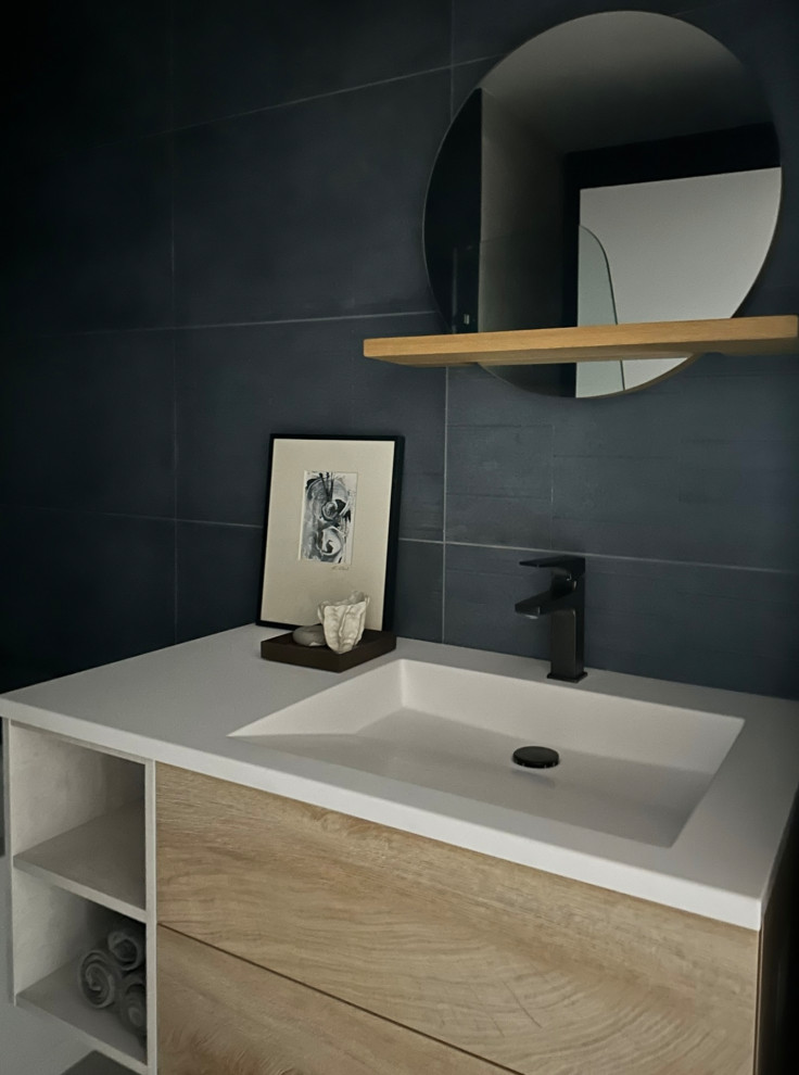 Design ideas for a mid-sized modern 3/4 bathroom in Seattle with flat-panel cabinets, light wood cabinets, a curbless shower, blue tile, porcelain tile, porcelain floors, an integrated sink, engineered quartz benchtops, grey floor, a hinged shower door, white benchtops, a niche, a double vanity and a floating vanity.