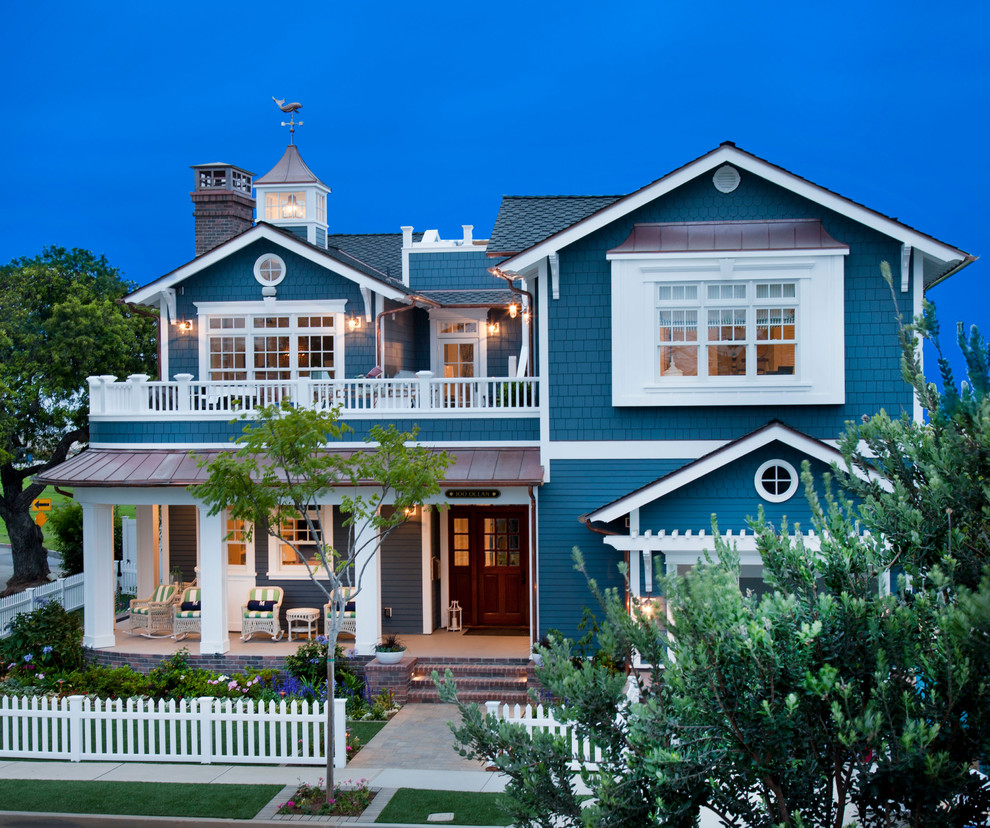 This is an example of a beach style two-storey blue exterior in San Diego with mixed siding and a gable roof.