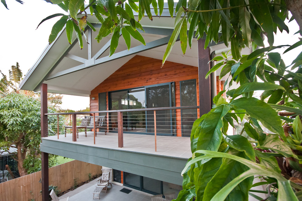 Photo of a contemporary balcony in Sunshine Coast with a roof extension.