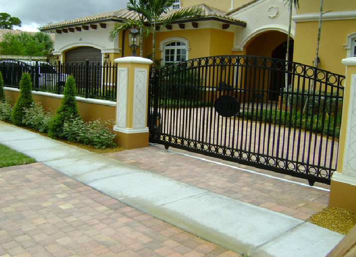 Design ideas for a front yard driveway in Miami with brick pavers.