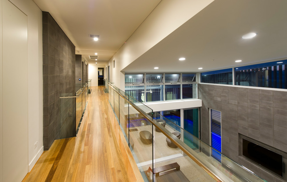 Inspiration for a contemporary hallway in Brisbane with white walls and light hardwood floors.