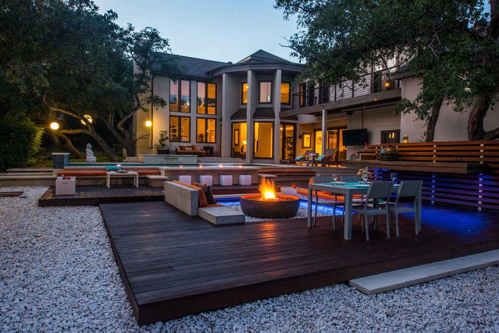 Inspiration for a contemporary backyard patio in Austin with a fire feature, decking and no cover.