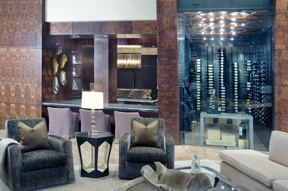 This is an example of a large modern wine cellar in Los Angeles with travertine floors and storage racks.
