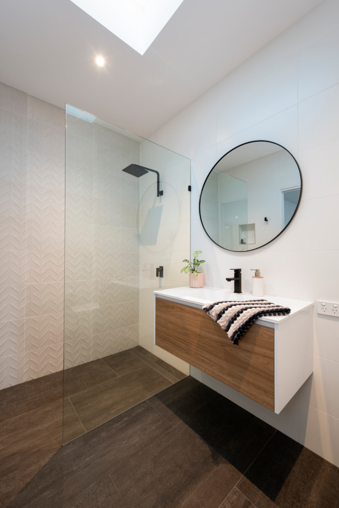 Inspiration for a small contemporary bathroom in Melbourne with light wood cabinets, an open shower, a two-piece toilet, white tile, porcelain tile, an integrated sink, an open shower, white benchtops, a single vanity and a floating vanity.
