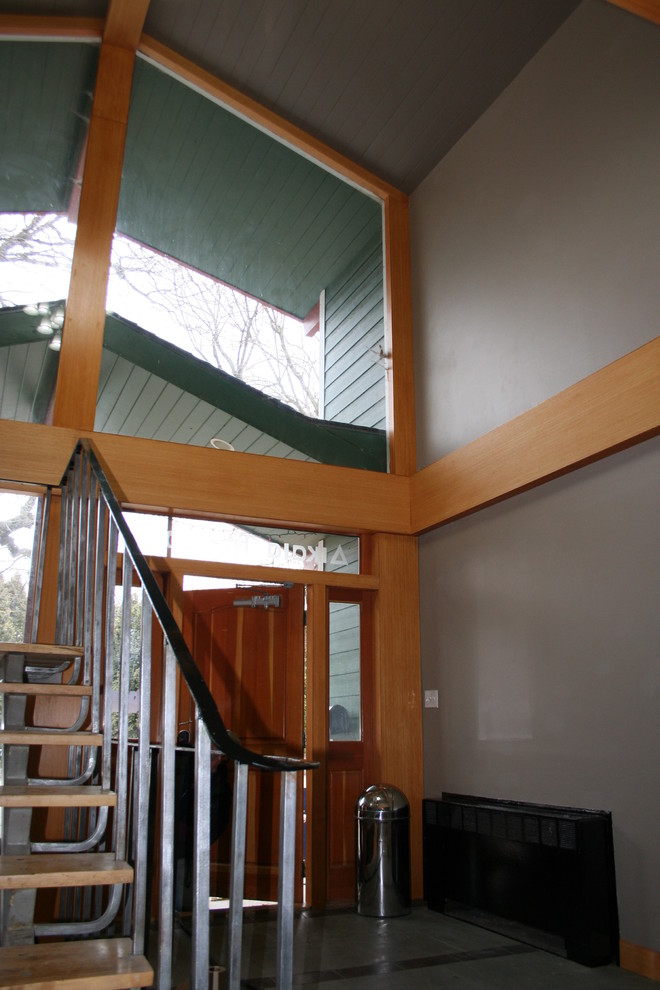 Photo of a mid-sized traditional wood staircase in Seattle with open risers and metal railing.