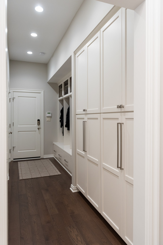 Design ideas for a large transitional mudroom in Indianapolis with grey walls, medium hardwood floors, a single front door, a white front door and brown floor.