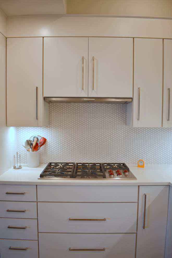 This is an example of a large contemporary l-shaped open plan kitchen in Boston with flat-panel cabinets, white cabinets, quartz benchtops, white splashback, mosaic tile splashback, with island and yellow benchtop.