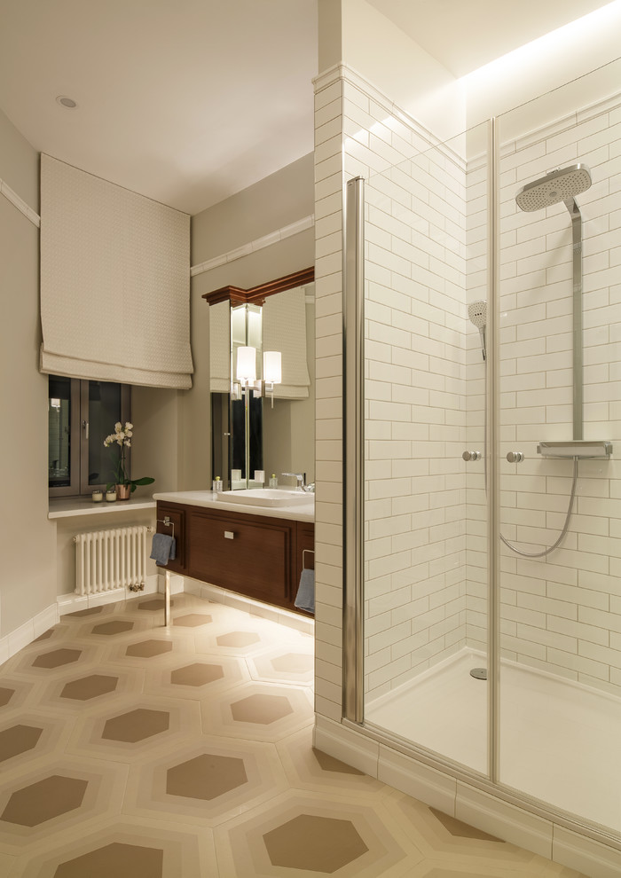 Mid-sized contemporary 3/4 bathroom in Moscow with raised-panel cabinets, medium wood cabinets, an alcove shower, a wall-mount toilet, white tile, ceramic tile, porcelain floors, a drop-in sink, solid surface benchtops and a hinged shower door.