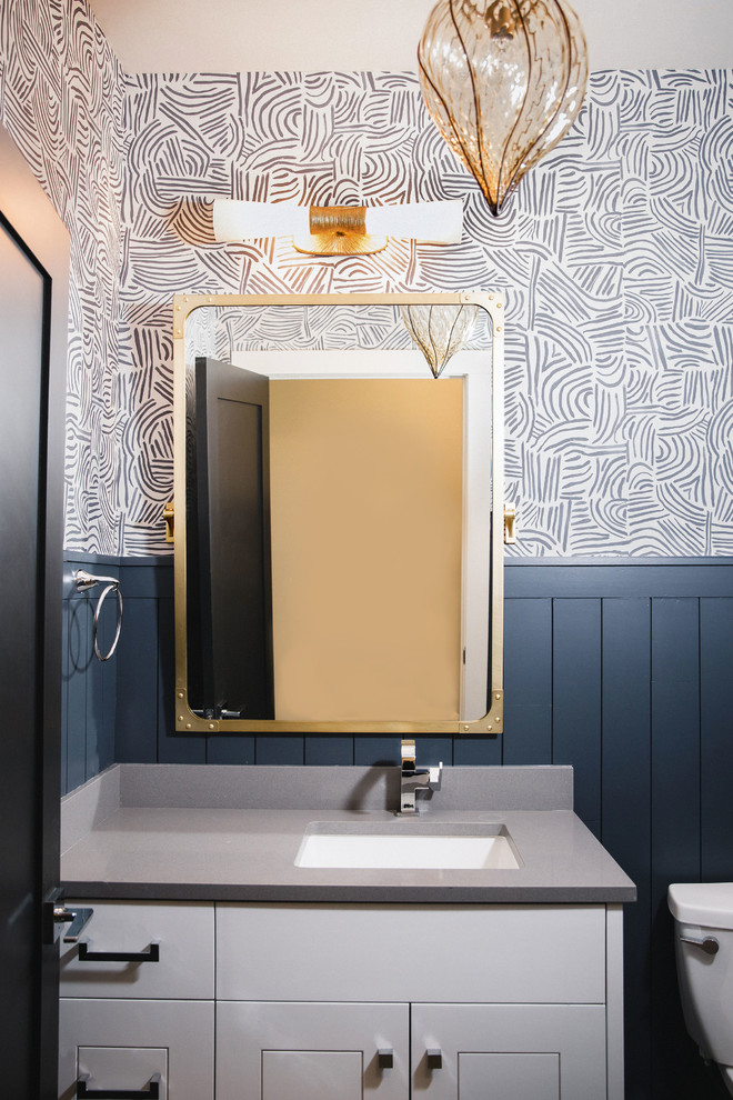 Small transitional 3/4 ceramic tile and gray floor home design photo in Austin with flat-panel cabinets, white cabinets, a one-piece toilet, blue walls, an undermount sink, granite countertops and gray countertops