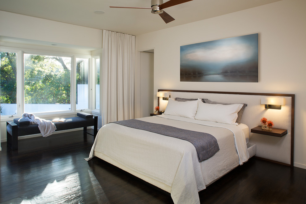 Inspiration for a mid-sized modern master bedroom in Charlotte with beige walls, dark hardwood floors and black floor.