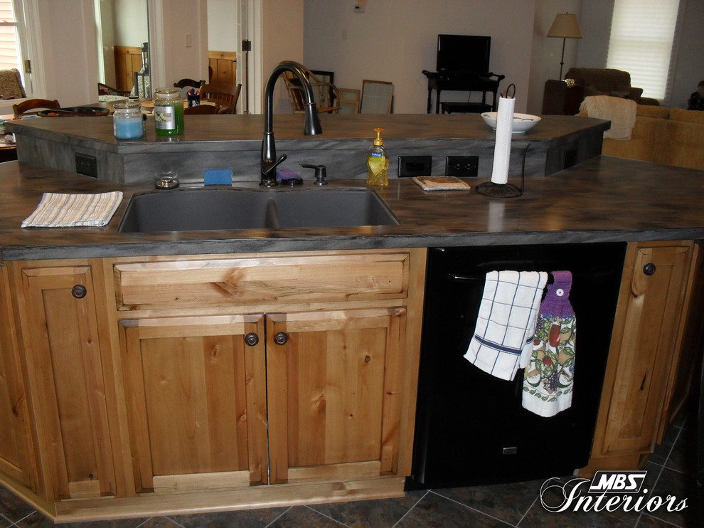 Eat-in kitchen - rustic l-shaped eat-in kitchen idea with a double-bowl sink, shaker cabinets, medium tone wood cabinets, solid surface countertops, yellow backsplash and black appliances