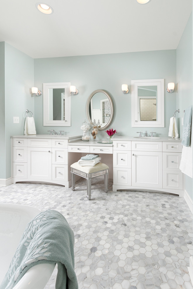 Traditional bathroom in Minneapolis with recessed-panel cabinets, white cabinets, mosaic tile, white tile and grey floor.