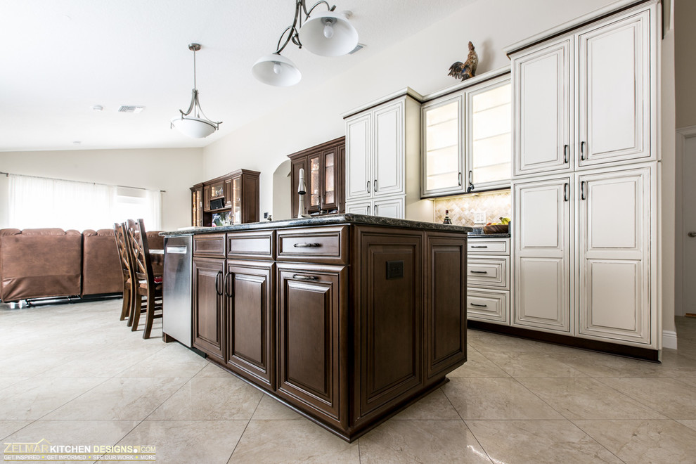 Design ideas for a large traditional u-shaped eat-in kitchen in Orlando with an undermount sink, raised-panel cabinets, beige cabinets, quartz benchtops, multi-coloured splashback, stone tile splashback, stainless steel appliances, porcelain floors and with island.