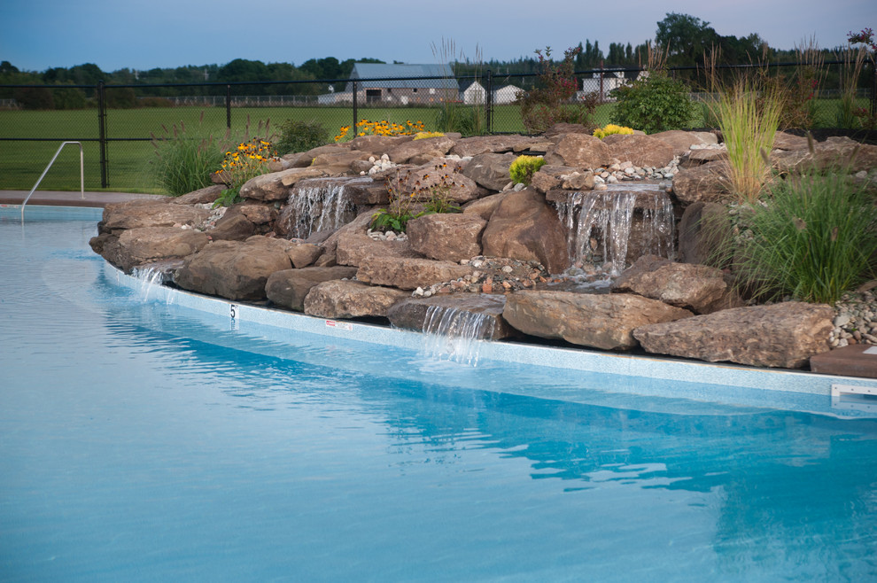 Huge mountain style courtyard stamped concrete and freeform natural pool fountain photo