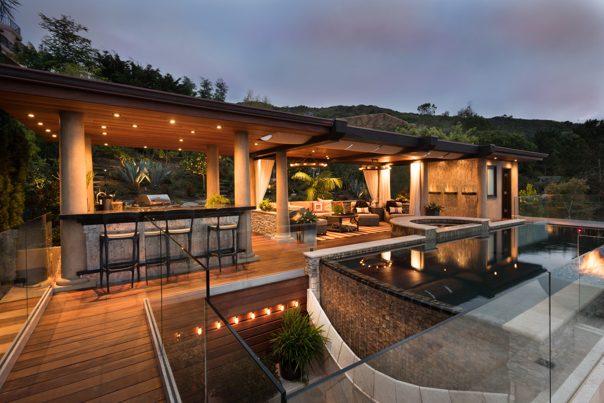 Inspiration for a mid-sized transitional backyard rectangular lap pool in San Diego with a hot tub and tile.