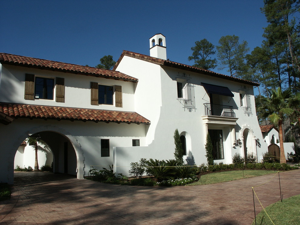 Photo of a large eclectic two-storey stucco white exterior in Houston.