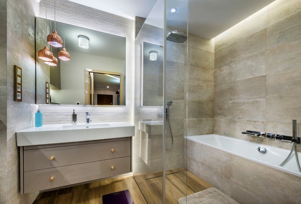 Inspiration for a large contemporary master bathroom in San Francisco with flat-panel cabinets, beige cabinets, an alcove tub, a corner shower, gray tile, porcelain tile, grey walls, medium hardwood floors, an integrated sink, solid surface benchtops, brown floor and white benchtops.
