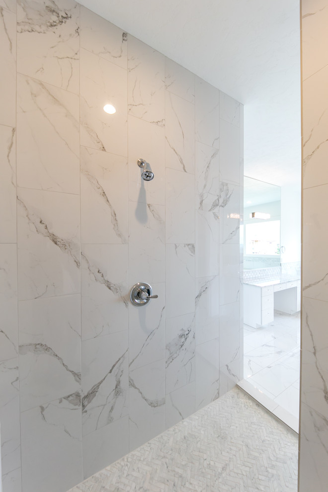 Photo of a large modern master bathroom in Seattle with shaker cabinets, white cabinets, a drop-in tub, an open shower, a two-piece toilet, white tile, marble, white walls, marble floors, an undermount sink, marble benchtops, white floor and a hinged shower door.