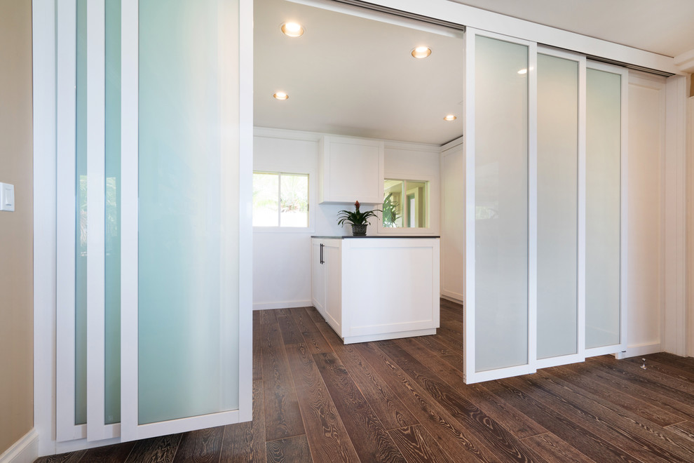 Photo of a large contemporary gender-neutral walk-in wardrobe in Hawaii with shaker cabinets and white cabinets.