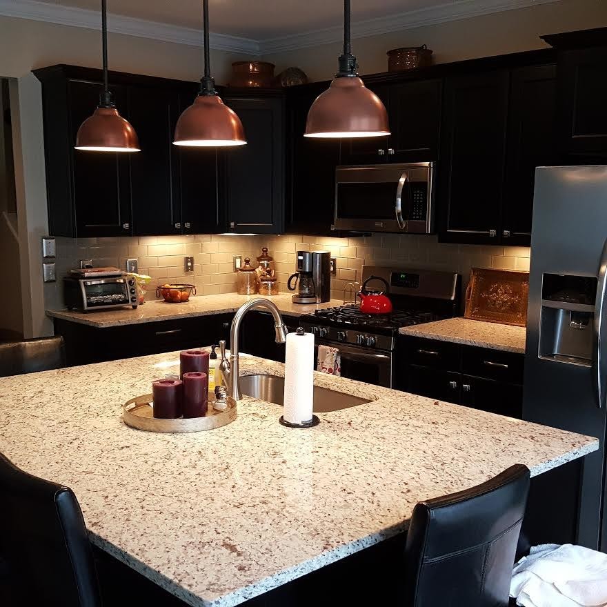 Design ideas for a mid-sized transitional l-shaped eat-in kitchen in Atlanta with an undermount sink, beaded inset cabinets, black cabinets, granite benchtops, beige splashback, glass tile splashback, stainless steel appliances and with island.