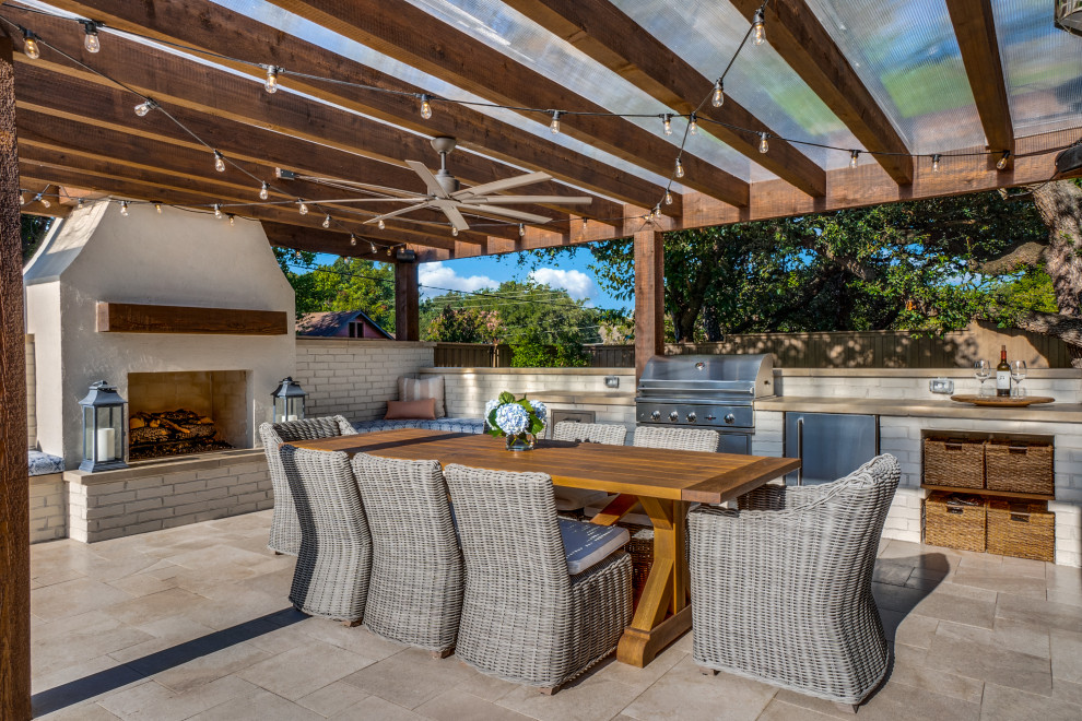 Design ideas for an expansive eclectic back patio in Dallas with a fireplace and a pergola.
