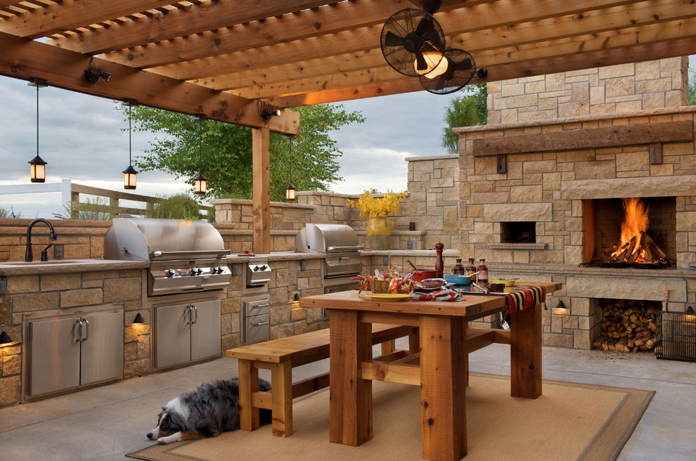 Mid-sized country backyard patio in Kansas City with concrete slab and a pergola.
