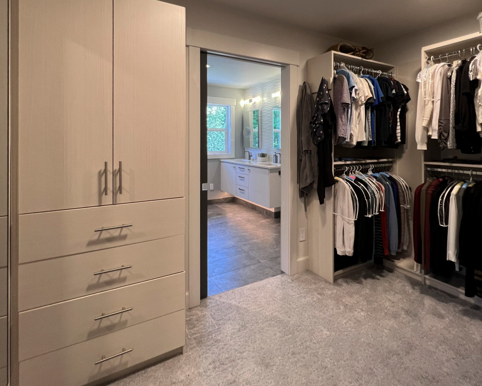 Large contemporary gender-neutral storage and wardrobe in Seattle with flat-panel cabinets, white cabinets, porcelain floors, grey floor and vaulted.