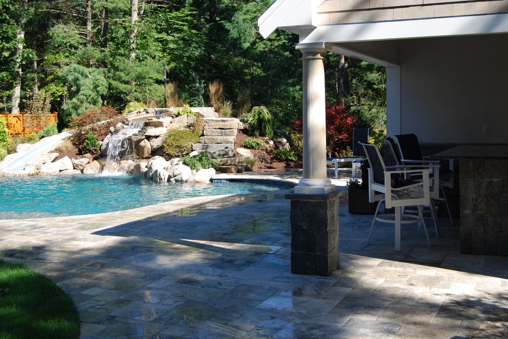 Water slide - mid-sized rustic backyard stone and kidney-shaped natural water slide idea in Boston