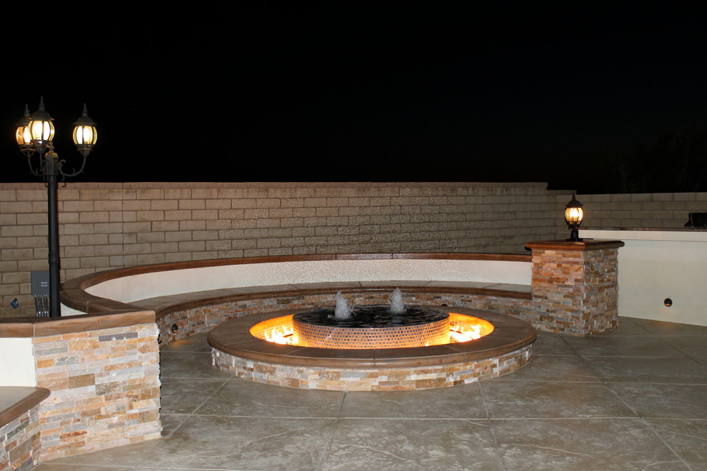 Inspiration for an expansive contemporary backyard patio in Los Angeles with a fire feature and stamped concrete.