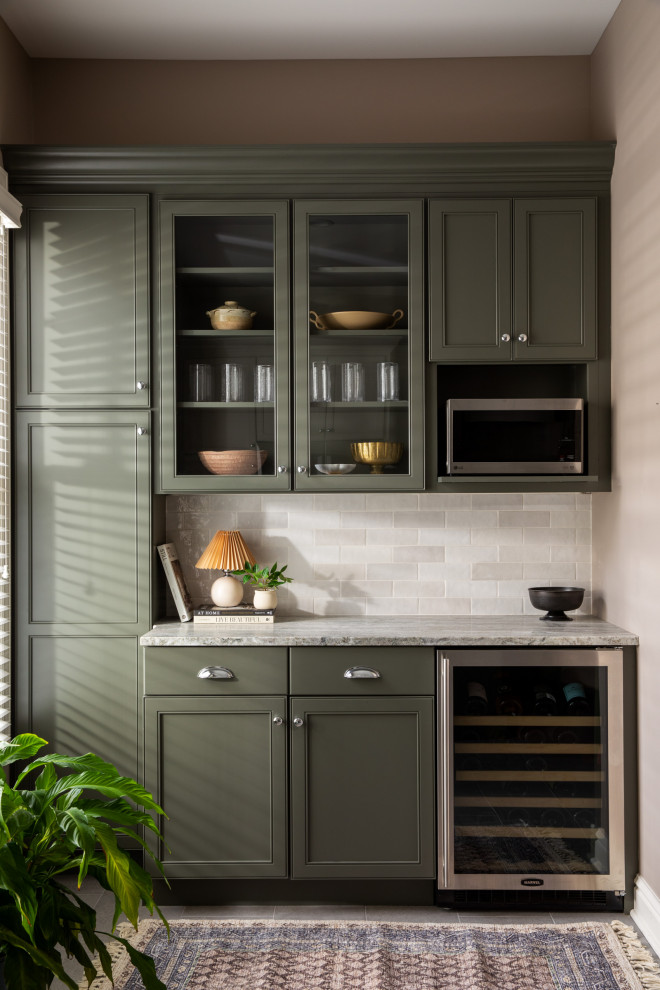 Example of a huge home bar design with recessed-panel cabinets, granite countertops, white backsplash and multicolored countertops