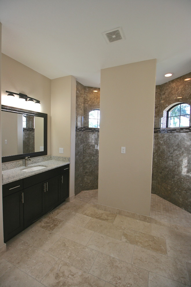 Inspiration for a mid-sized contemporary master bathroom in Miami with an undermount sink, flat-panel cabinets, dark wood cabinets, granite benchtops, an open shower, a one-piece toilet, beige tile, beige walls and travertine floors.