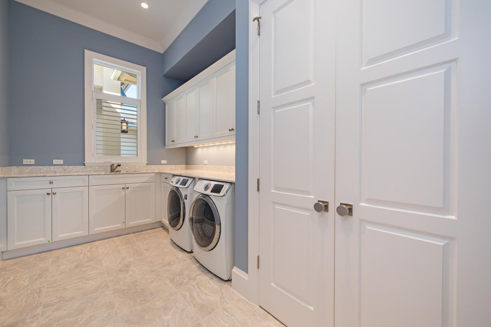 Photo of a large modern u-shaped dedicated laundry room in Other with shaker cabinets, white cabinets, tile benchtops, ceramic floors, beige floor, beige benchtop and recessed.