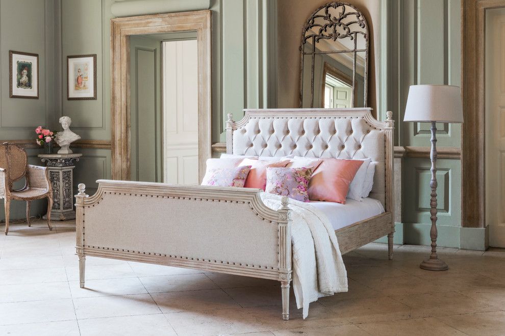 Inspiration for a traditional master bedroom in Sussex with green walls and limestone floors.