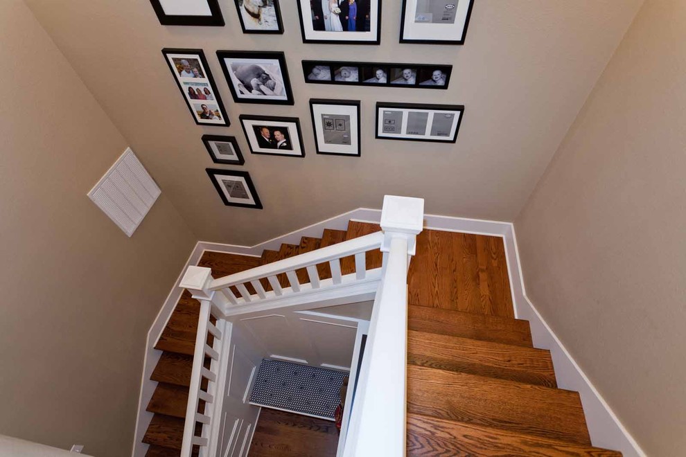 This is an example of a mid-sized traditional wood u-shaped staircase in Portland with wood risers.