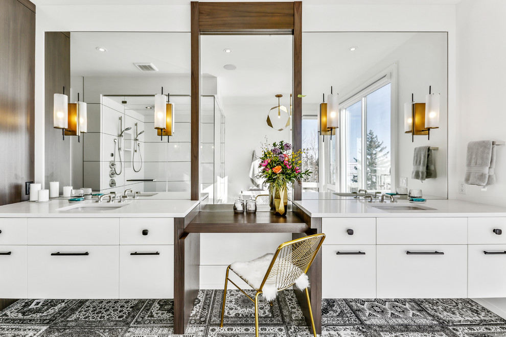 Inspiration for a contemporary master bathroom in Calgary with flat-panel cabinets, white cabinets, a corner shower, white walls, an undermount sink, black floor, a hinged shower door and white benchtops.
