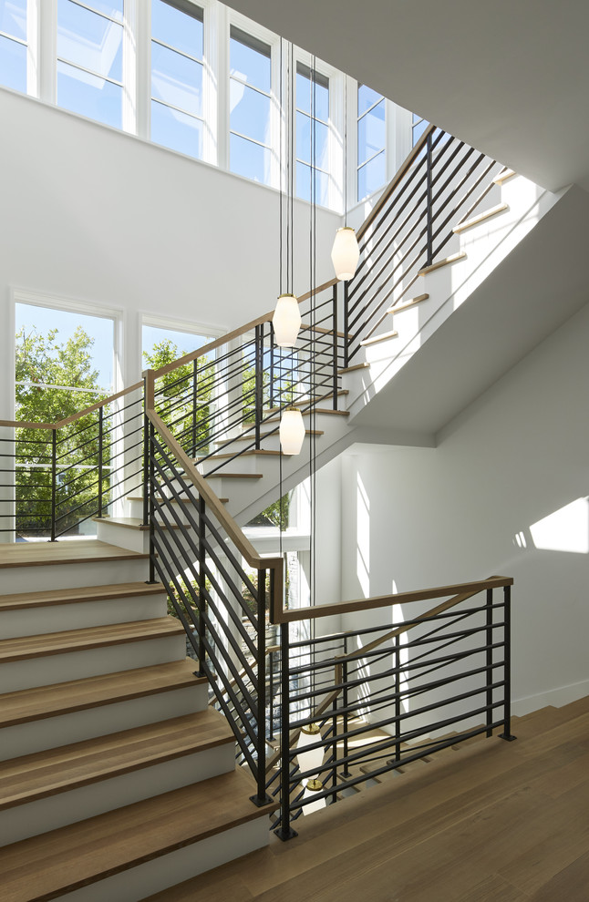 This is an example of a contemporary wood staircase in Minneapolis with painted wood risers.